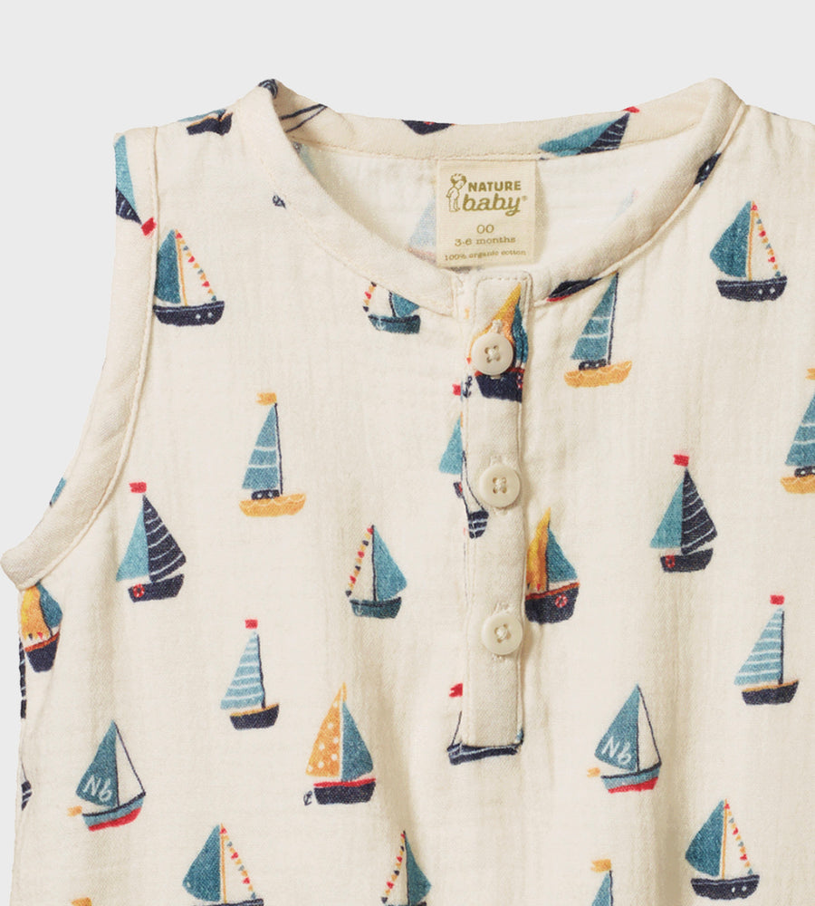 Baby onesie with sailboat pattern on a white background