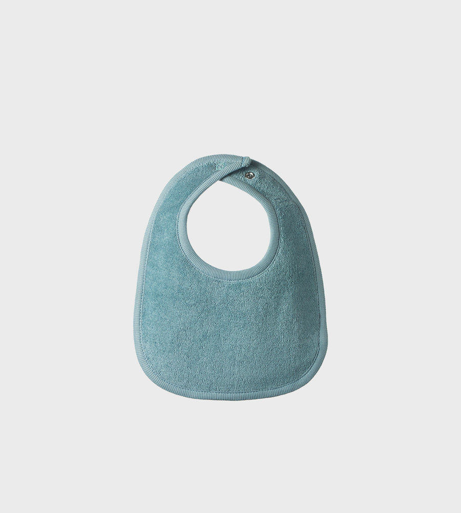 Blue bib on a light gray background