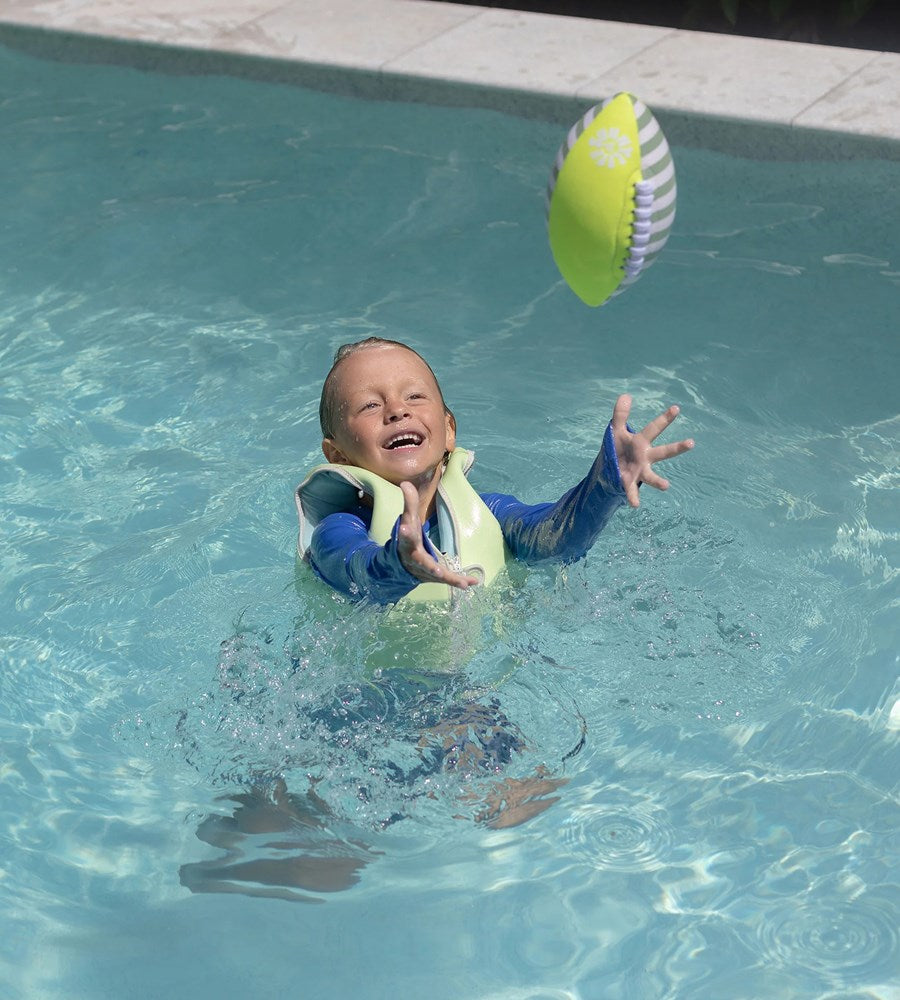 Child playing with a ball in a pool