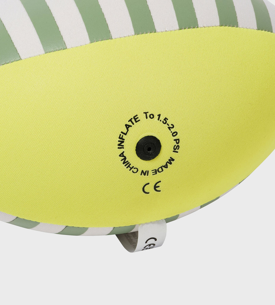 Close-up of a green and white striped inflatable pool toy with a black valve and text.