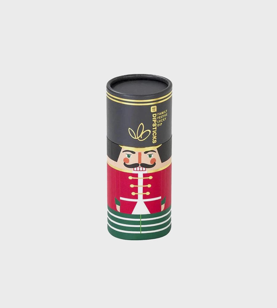 Decorative cylindrical tube with a nutcracker design on a light gray background