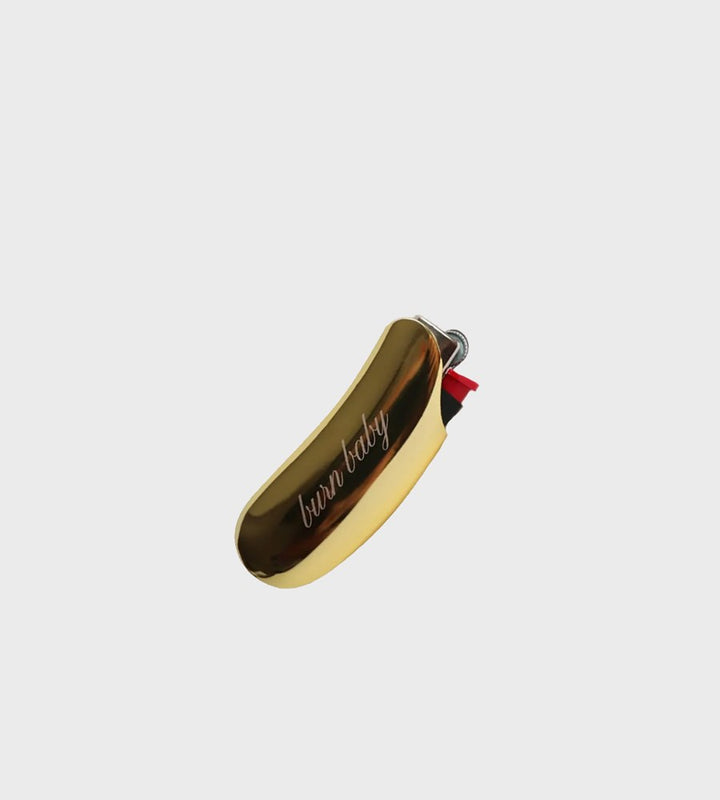 Gold lighter with 'burn baby' text on a white background