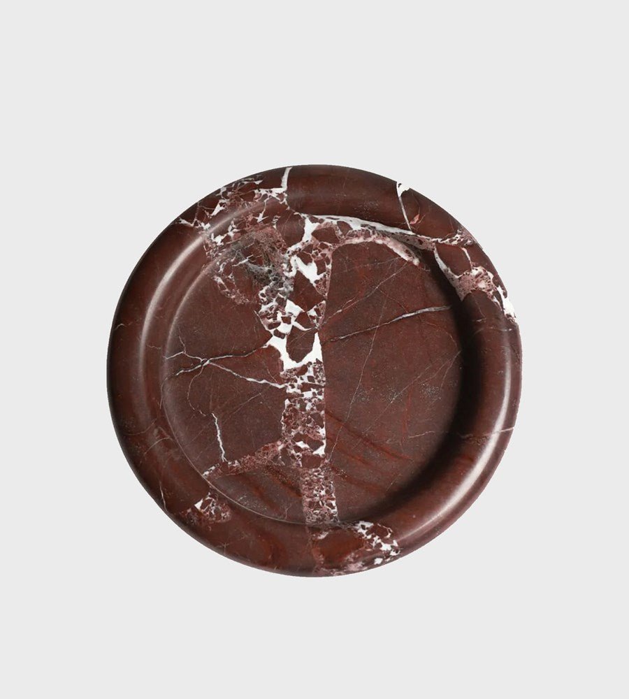 Round brown marble coaster on a light gray background