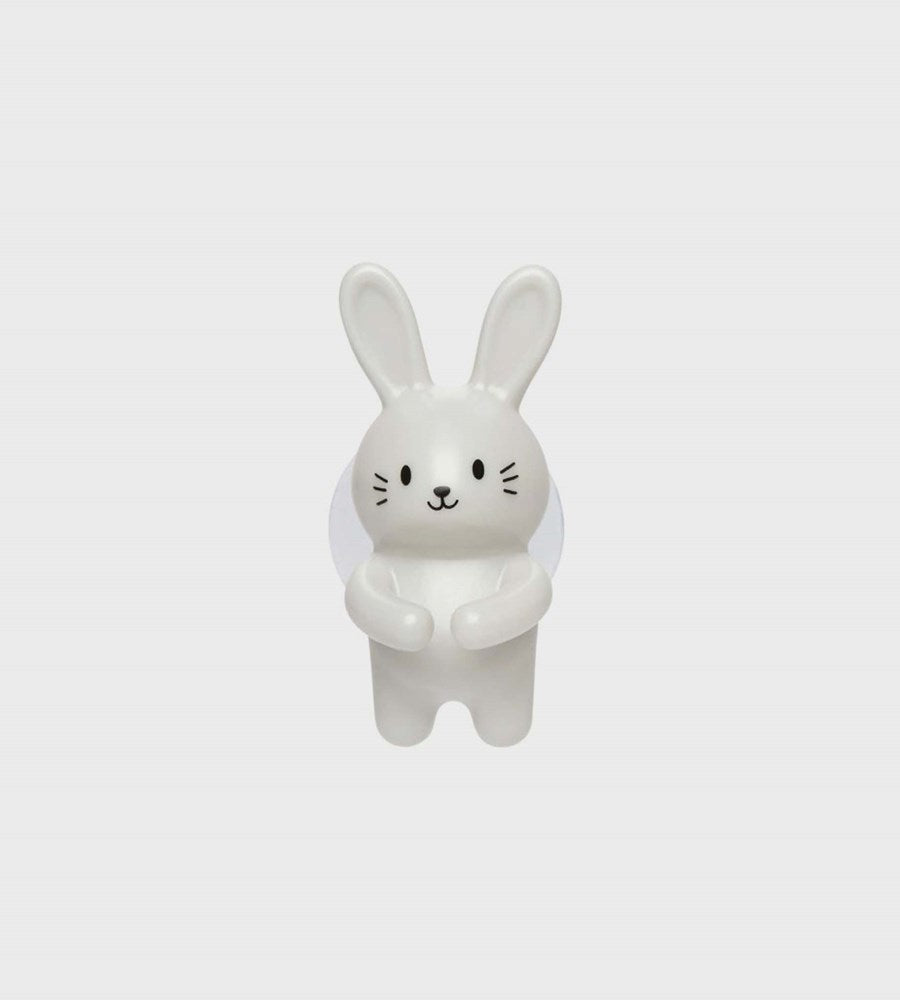 White ceramic rabbit-shaped object on a light gray background
