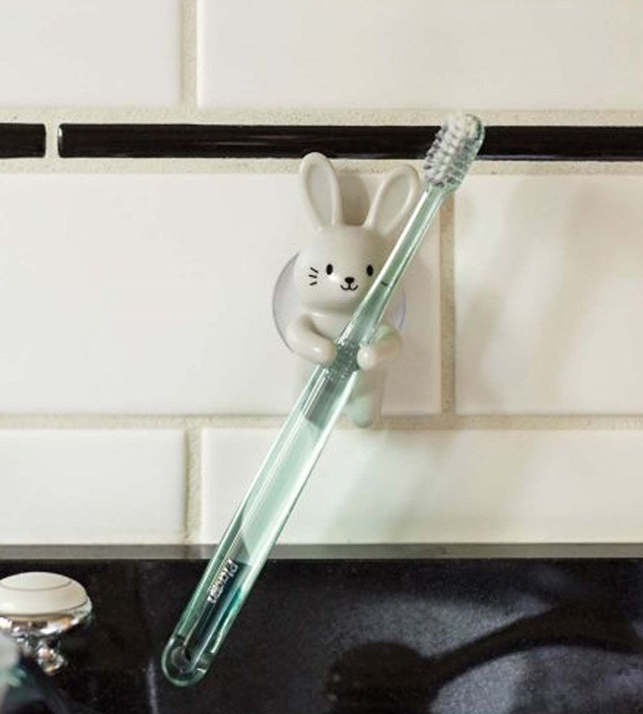 Clear straw with a rabbit-shaped holder attached to a kitchen counter.