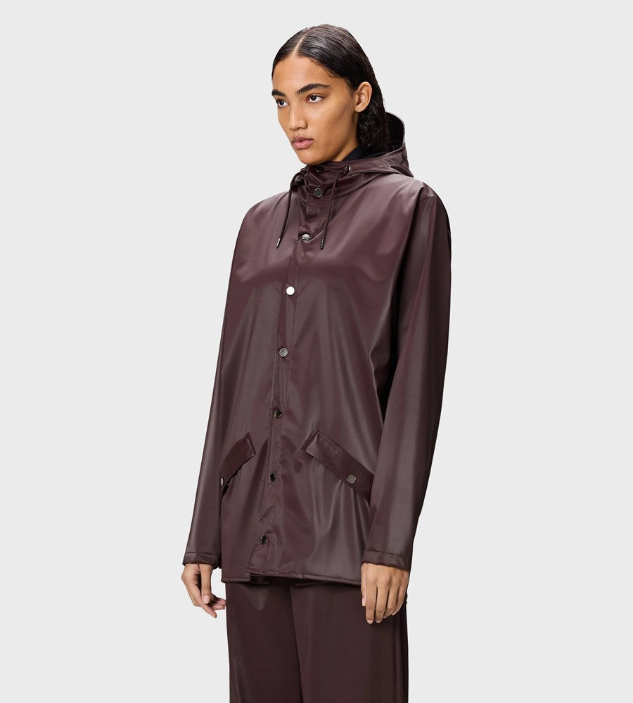 Woman wearing a brown raincoat on a white background
