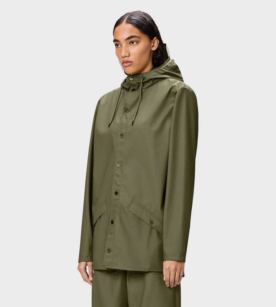 Woman wearing a green raincoat on a white background