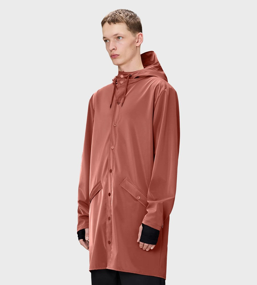 Person wearing a brown raincoat on a light gray background