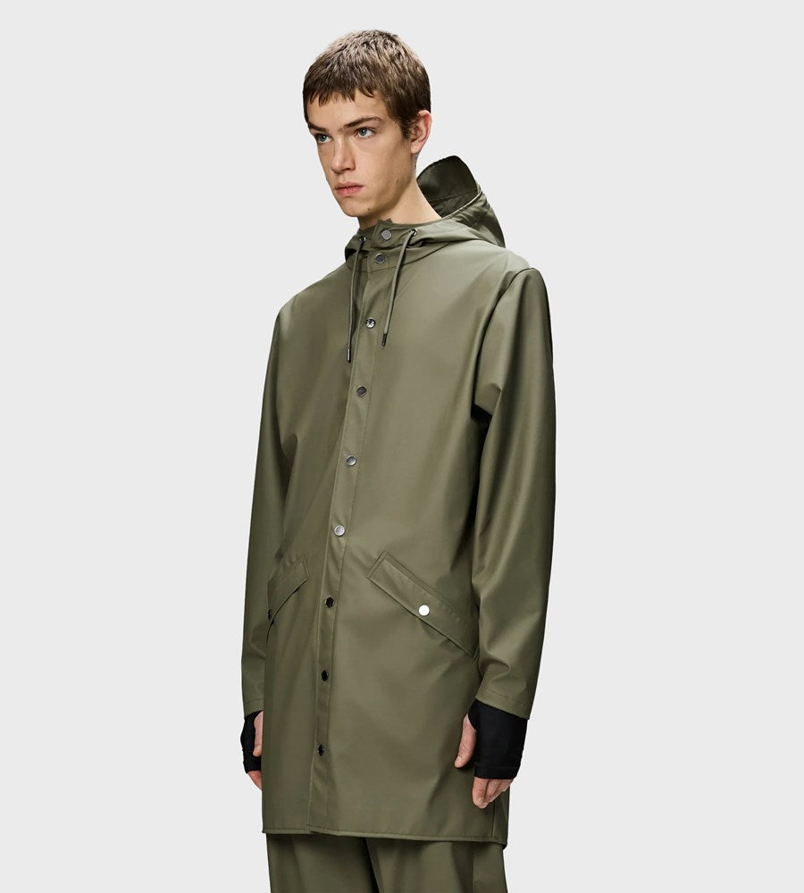 Person wearing a green raincoat on a white background