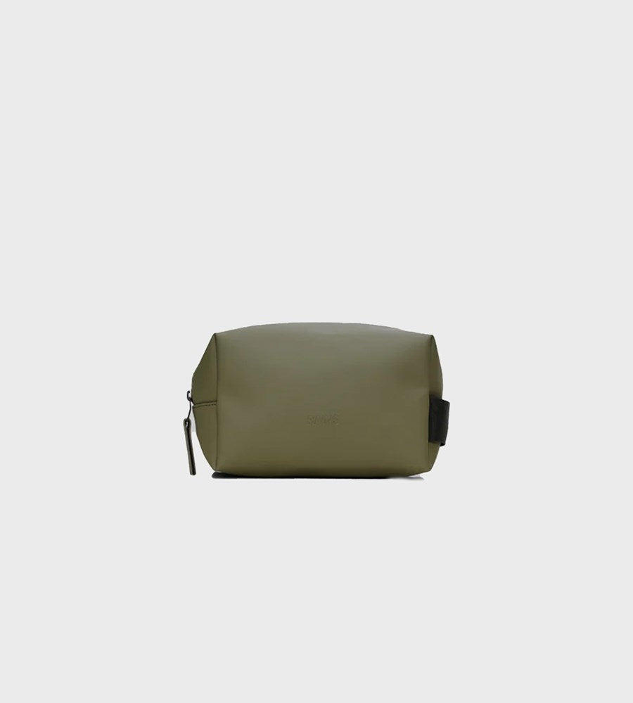 Green toiletry bag on a light gray background