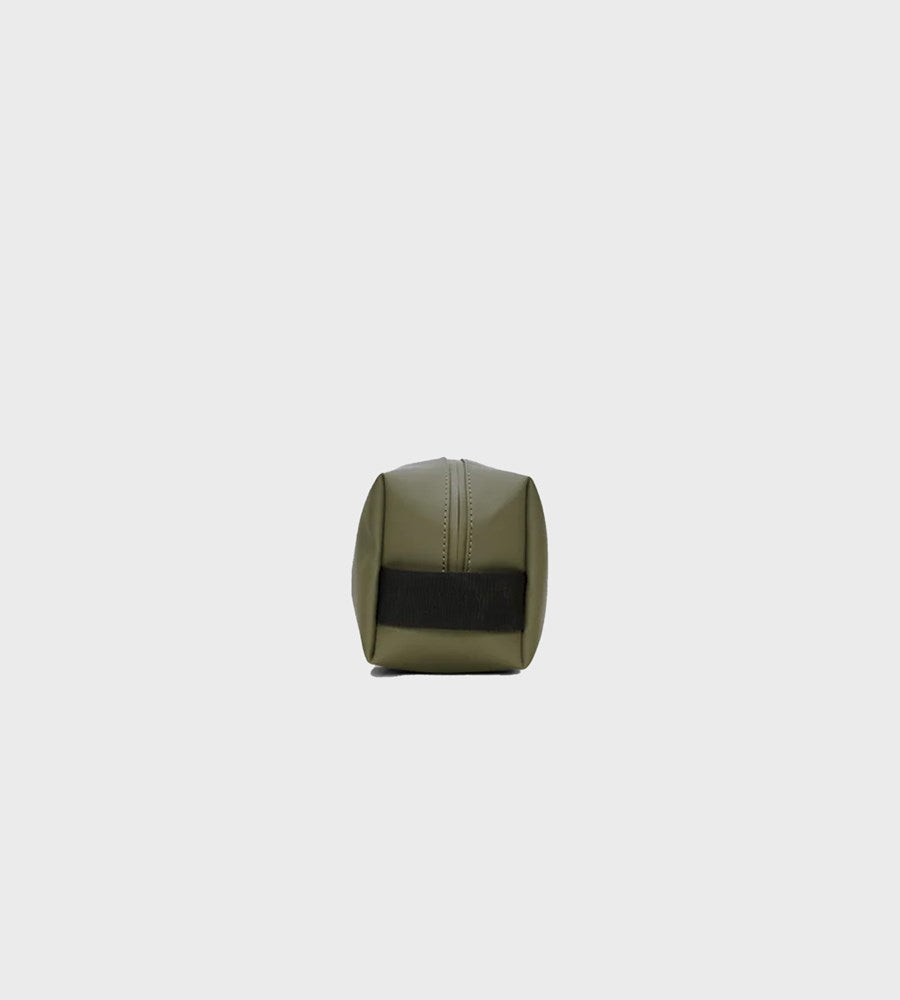 Green cylindrical object with black band on a white background