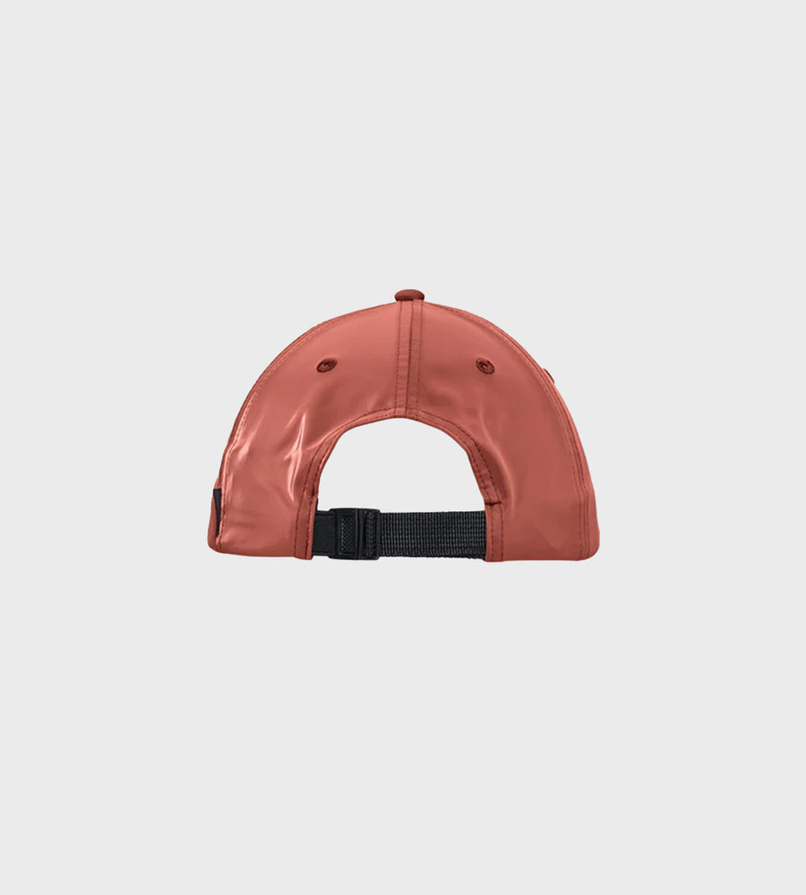 Brown cap with a black strap on a light gray background