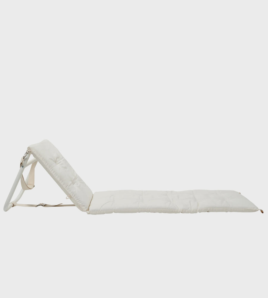 White lounge chair on a light gray background
