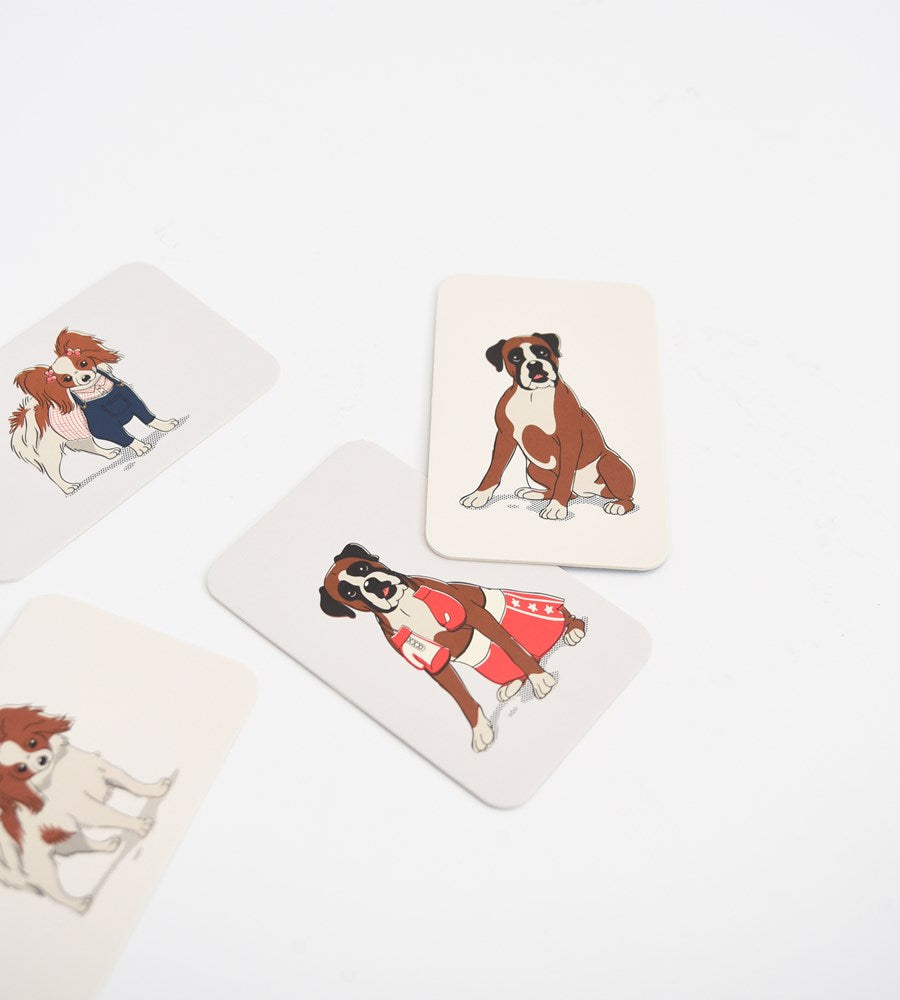 Set of playing cards with dog illustrations on a white background