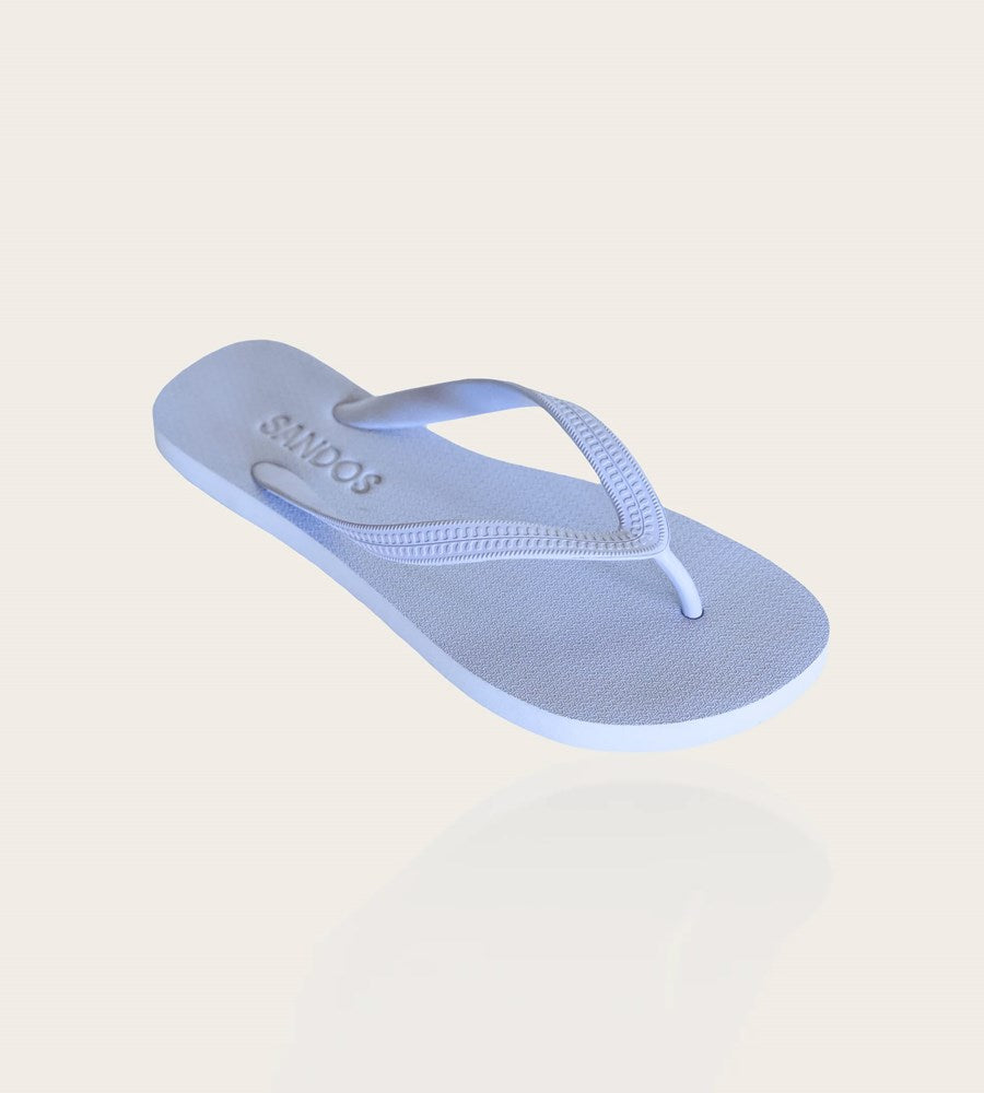 Light blue flip-flop sandal on a beige background