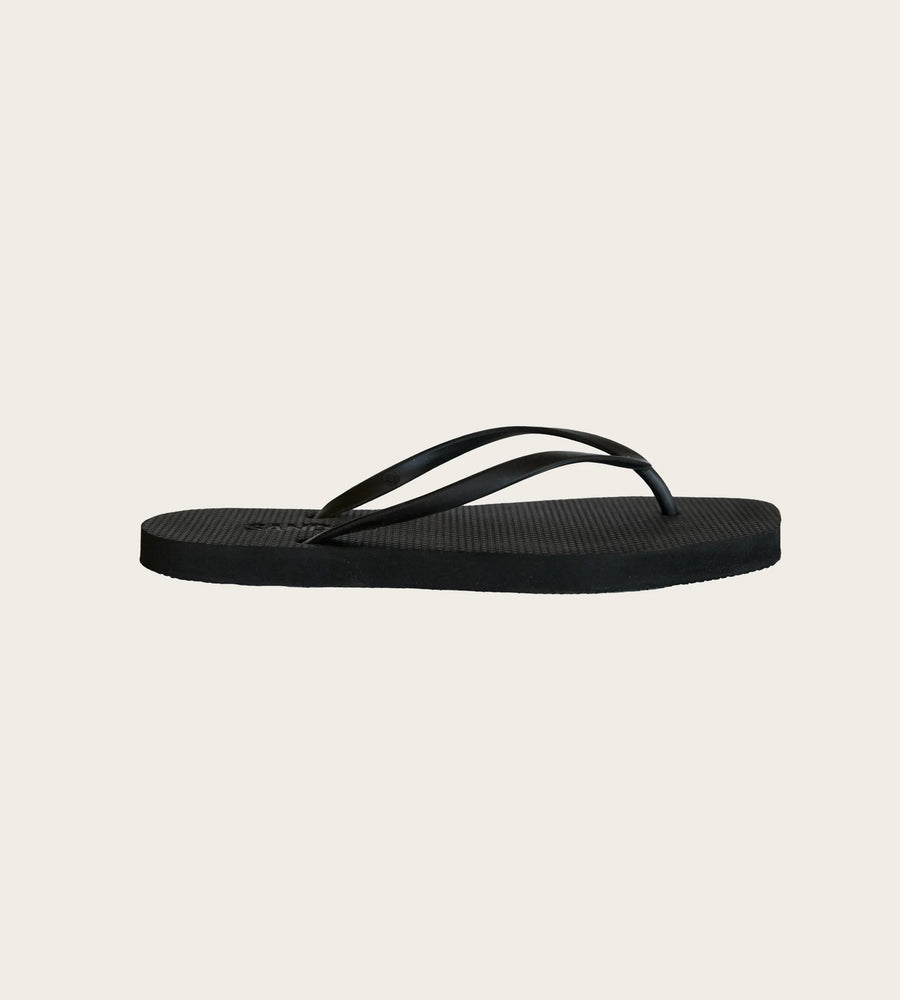Black sandal on a beige background