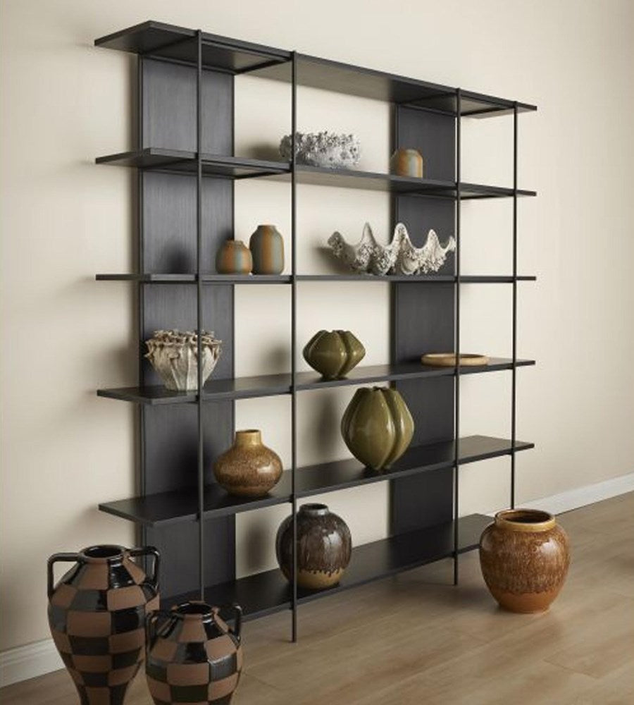 Black shelving unit with decorative vases against a beige wall