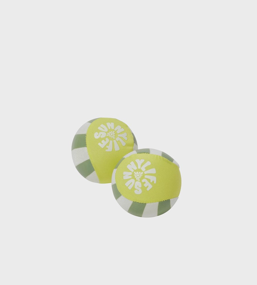 Two round green and gray objects with white patterns on a light gray background