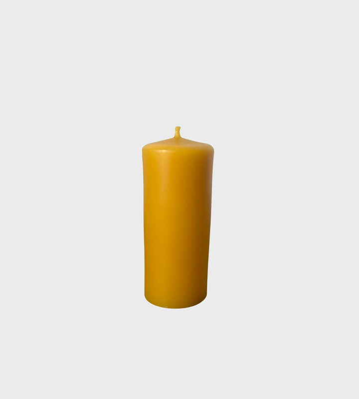 Yellow candle on a light gray background