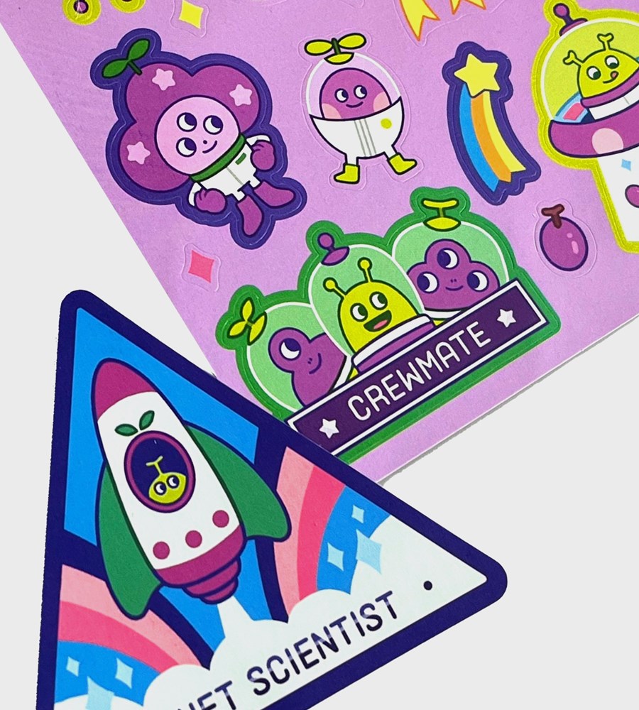 Colorful space-themed stickers on a purple background