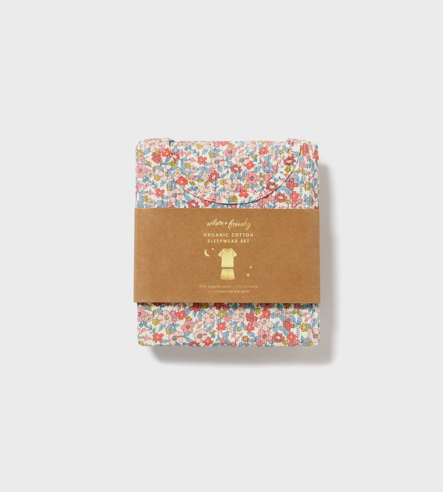 Set of two floral-patterned products with a brown packaging label on a light gray background