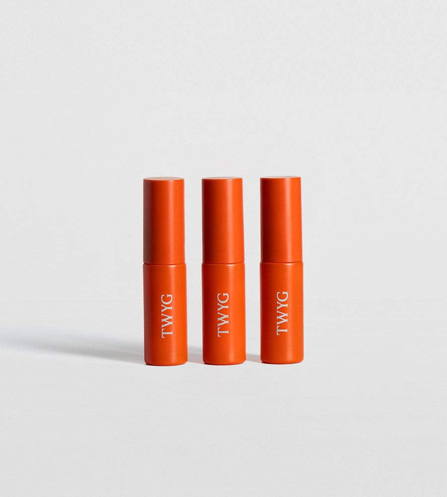 Three orange TWYG products on a light gray background