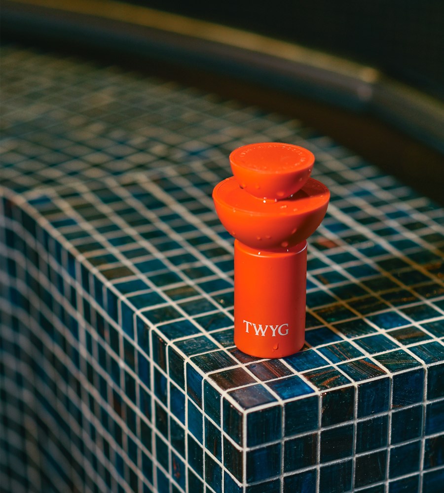 Red TWYG product on a blue tiled surface
