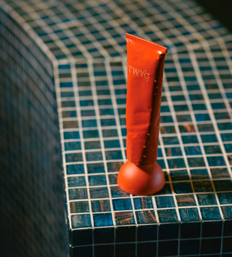 Red tube of TWG cream on a blue tiled surface