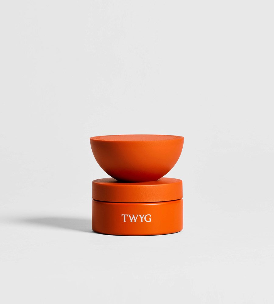 Orange container with 'TWYG' branding on a light gray background