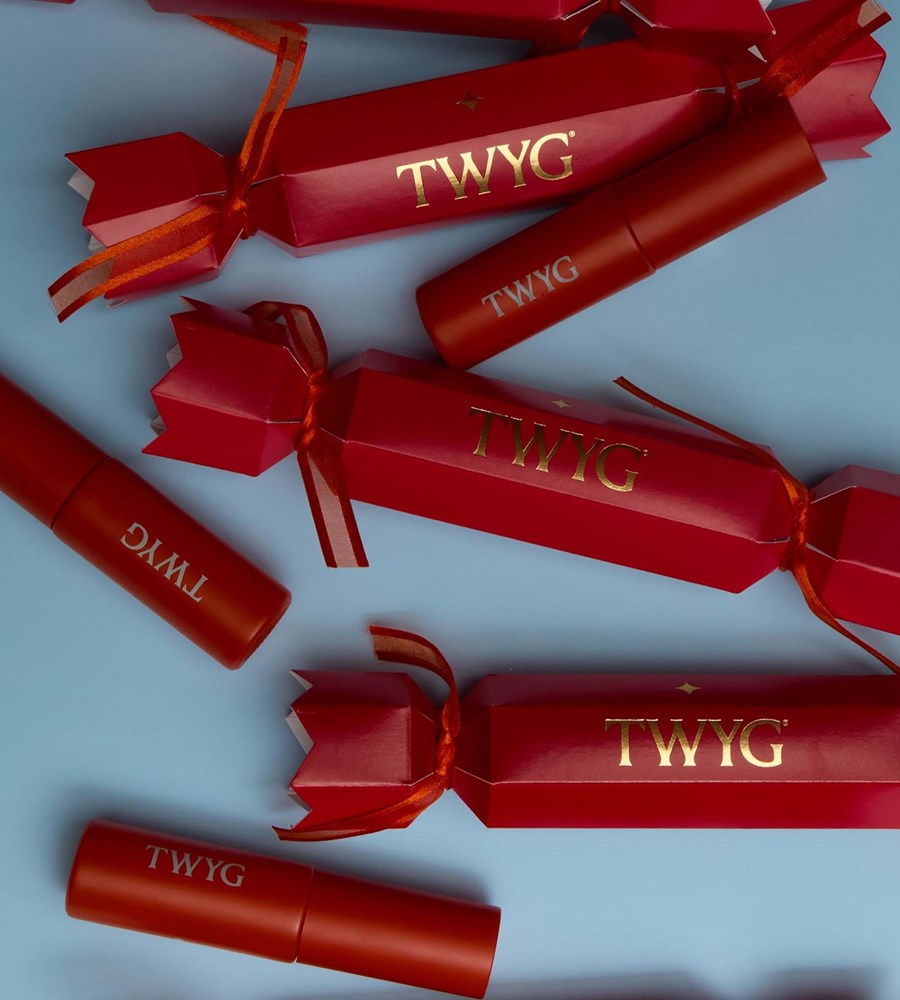 Red TWYG lip products on a light blue background