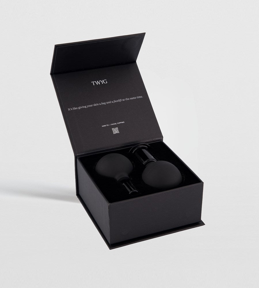 Black product in an open box with 'TWYG' branding on a light gray background