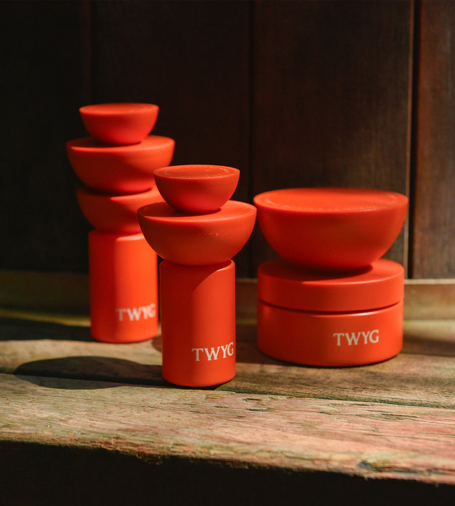 Red containers with 'TWYG' branding on a wooden surface