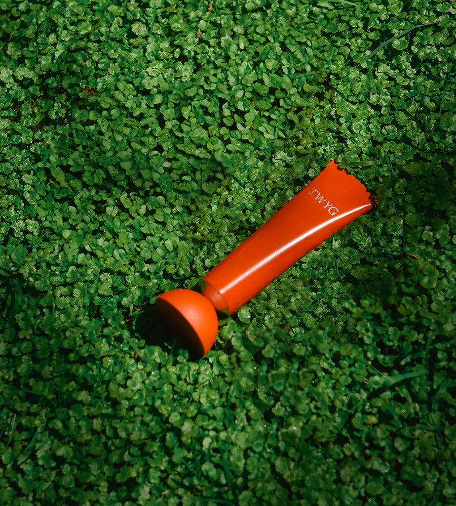 Orange object with 'TWYG' branding on a green grass-like surface