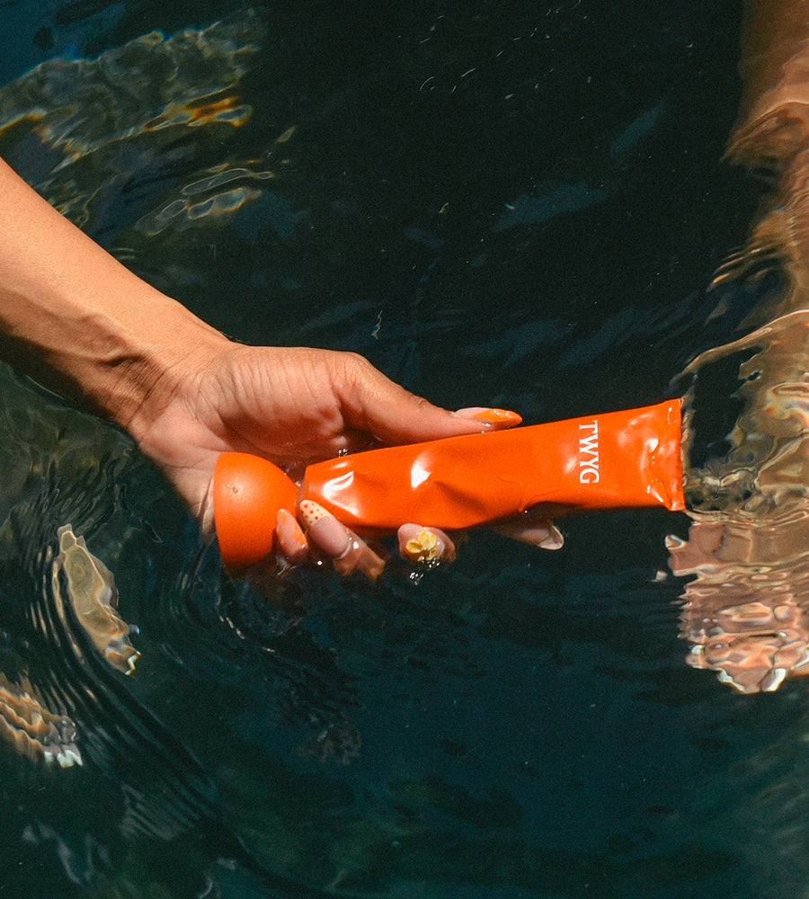 Orange TWG product held over water