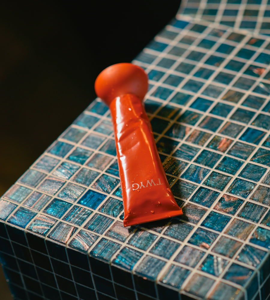 Red tube on a blue tiled surface