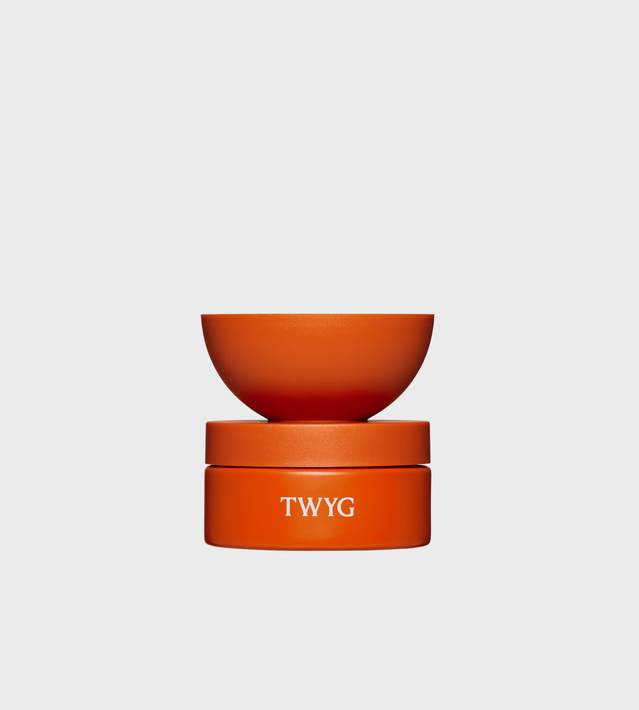 Orange container with lid on a light gray background