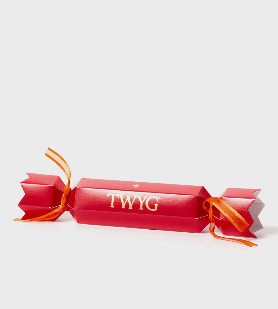 Red cracker with orange string and 'TWYG' branding on a white background