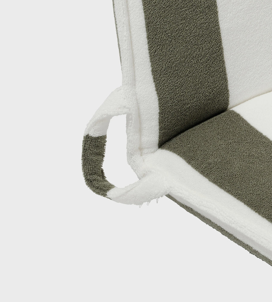Close-up of a chair with gray cushioned seat and white frame on a light gray background