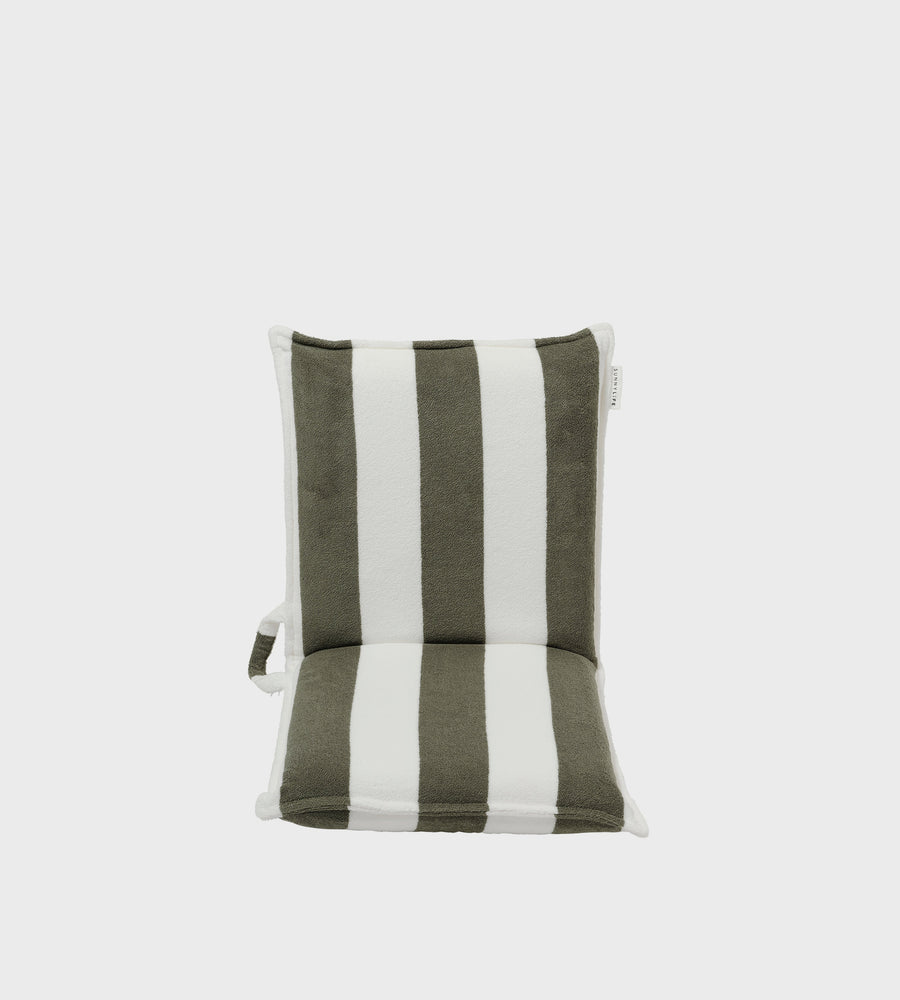 Striped cushion with green and white stripes on a light gray background