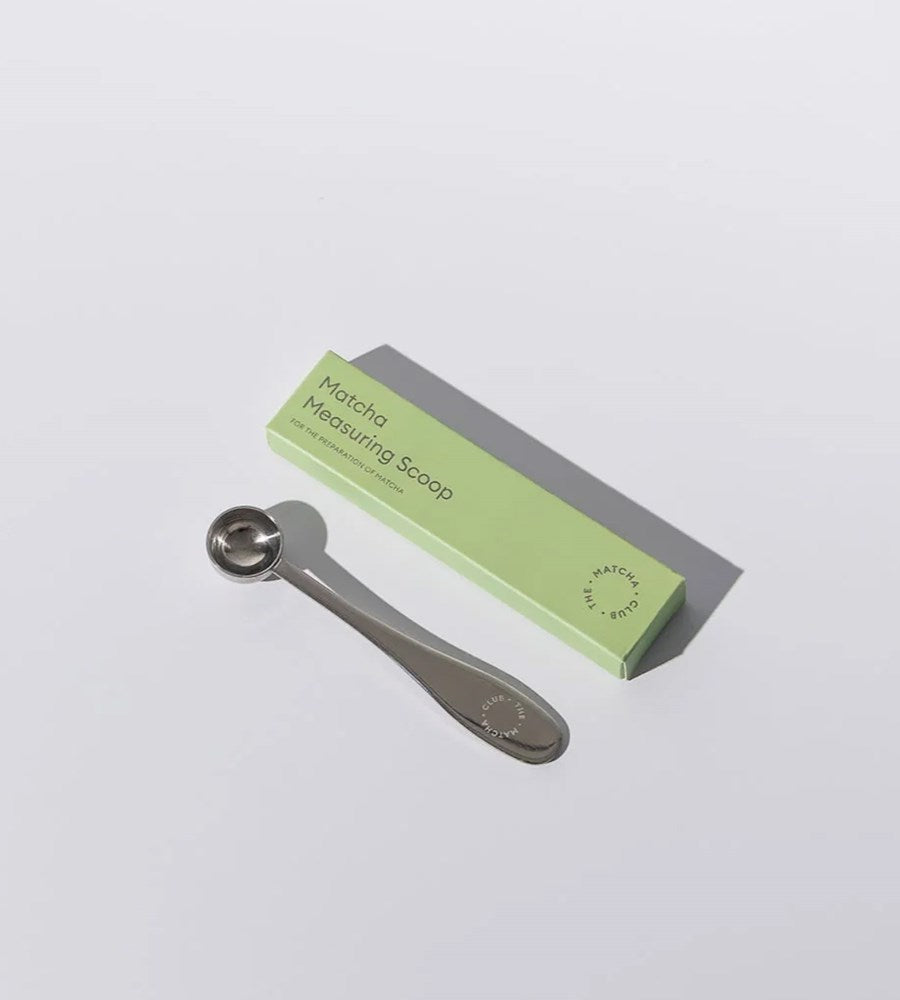 Matcha measuring scoop with green packaging on a white background