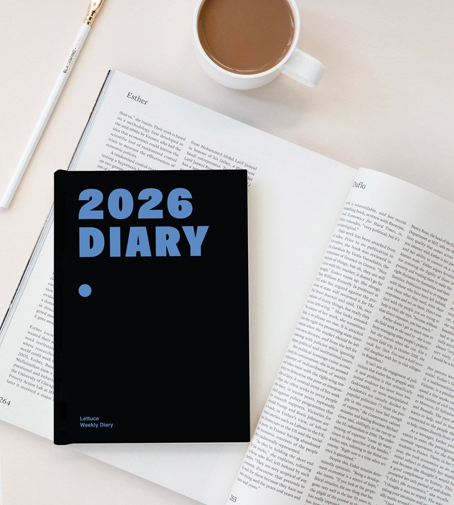2026 diary on an open book with a cup of coffee