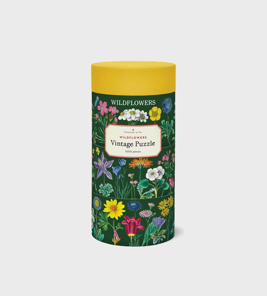Jigsaw puzzle box with floral design and yellow lid on a white background