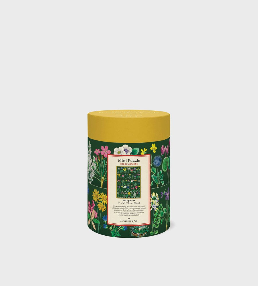  cylindrical puzzle box with floral design and yellow lid on a white background