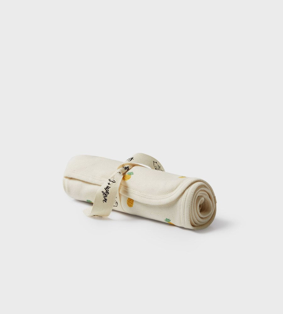 Rolled-up towel with branding on a light gray background