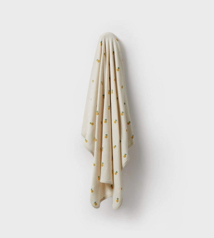 Beige towel with gold polka dots on a white background