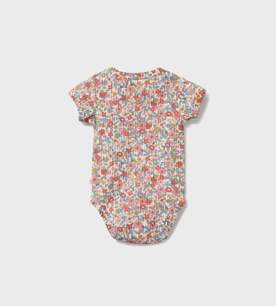 Floral baby bodysuit on a light gray background