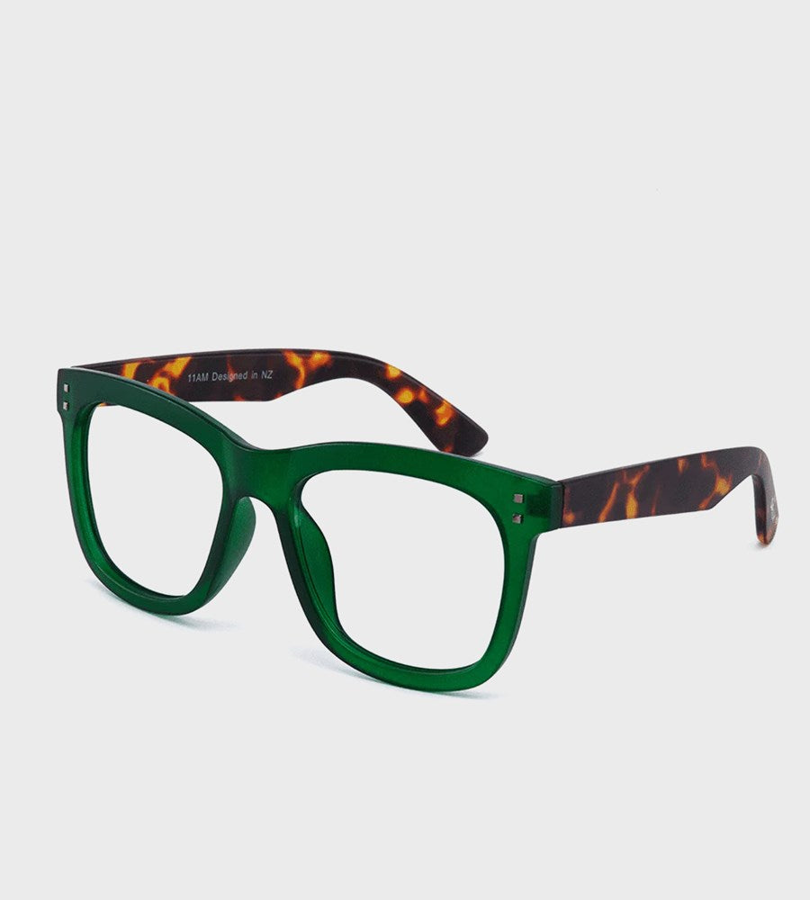 Green eyeglasses with tortoiseshell arms on a light gray background