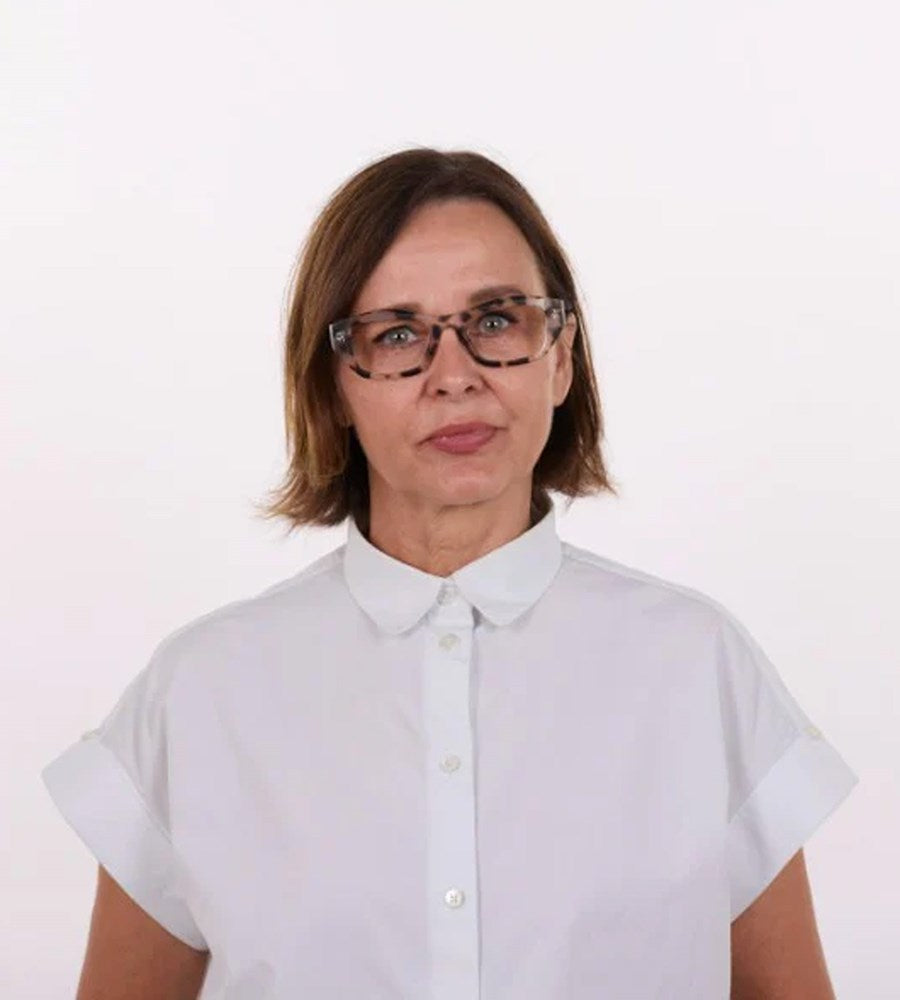 Person wearing a white shirt and glasses on a plain background