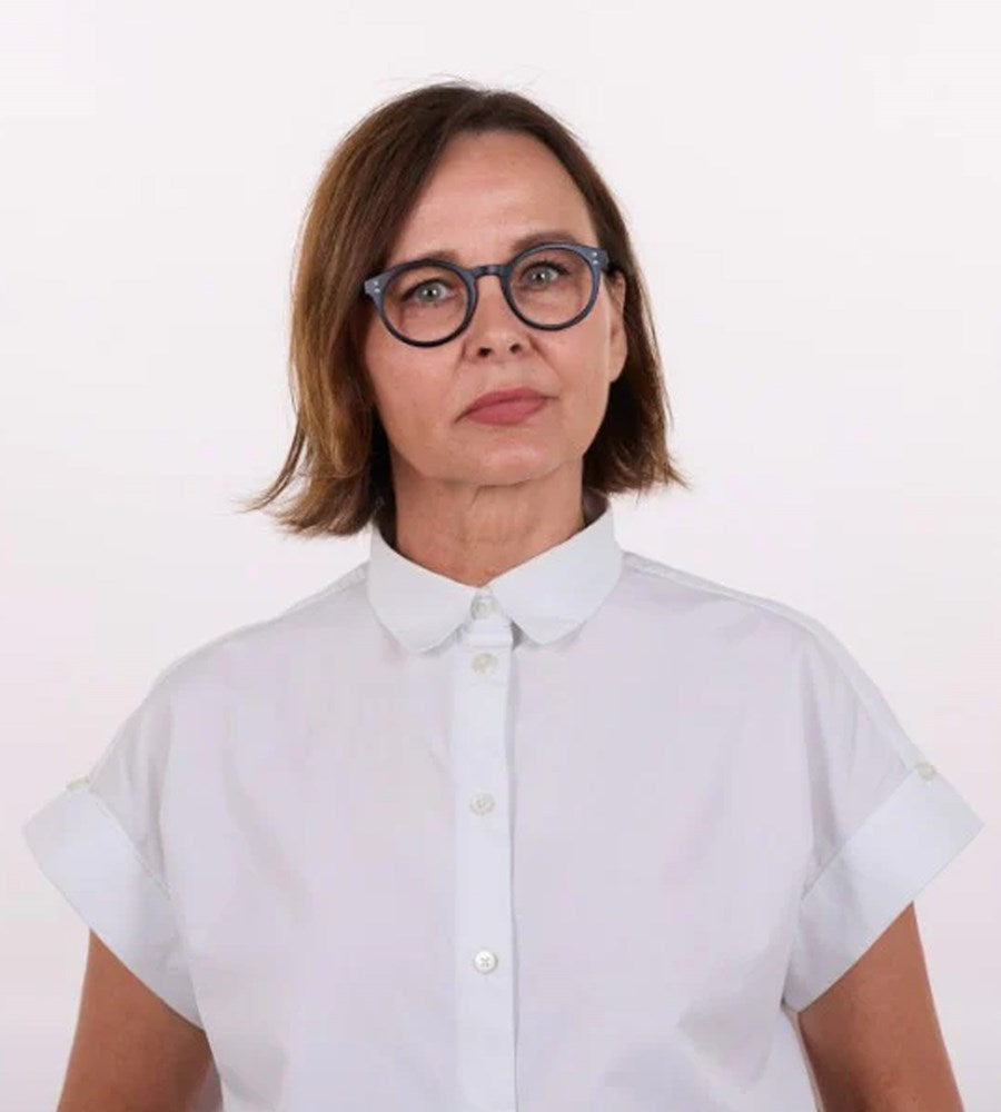 Person wearing a light blue shirt with a white background