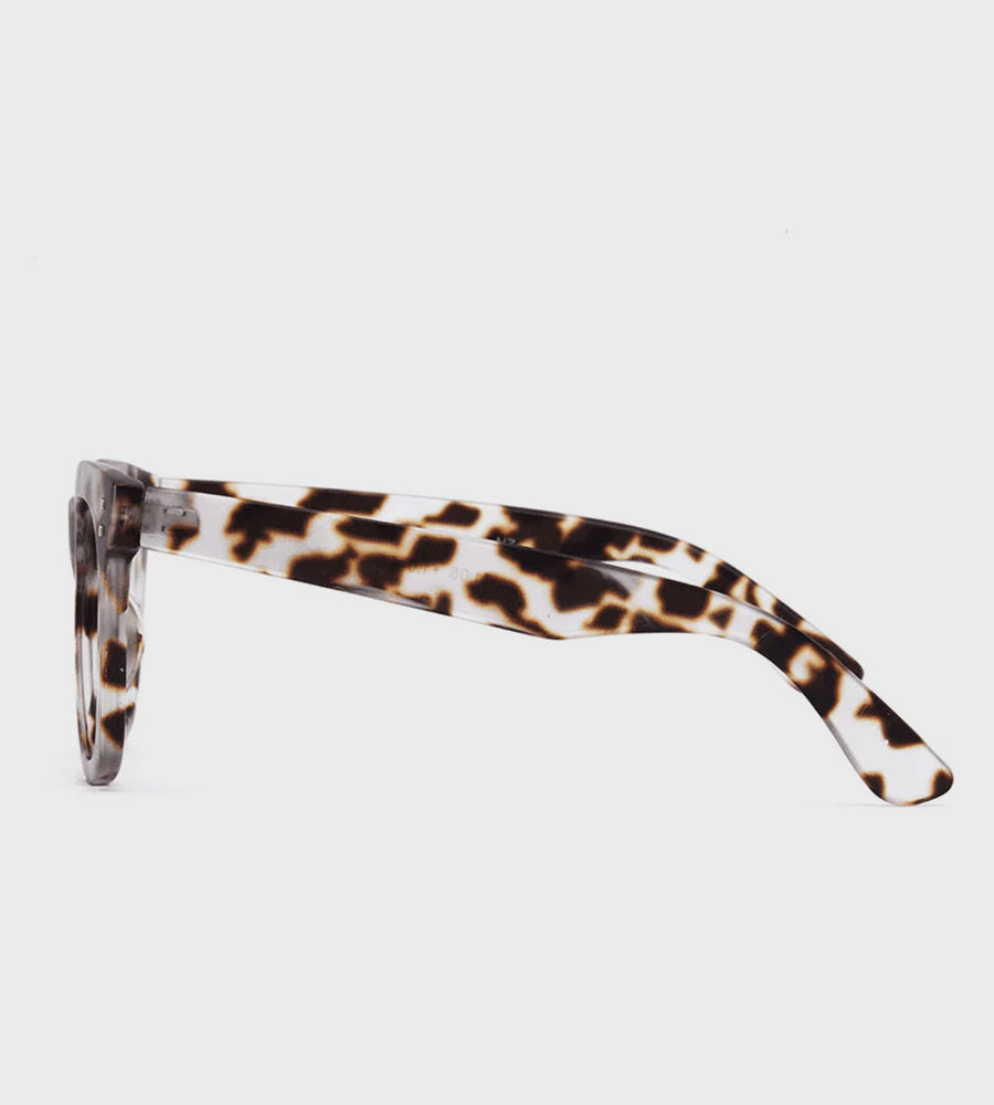 Sunglasses with a tortoiseshell frame on a light gray background
